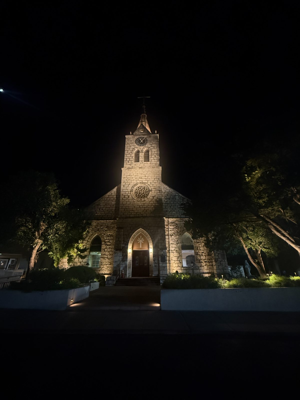 Stone church facade lit in warm white.